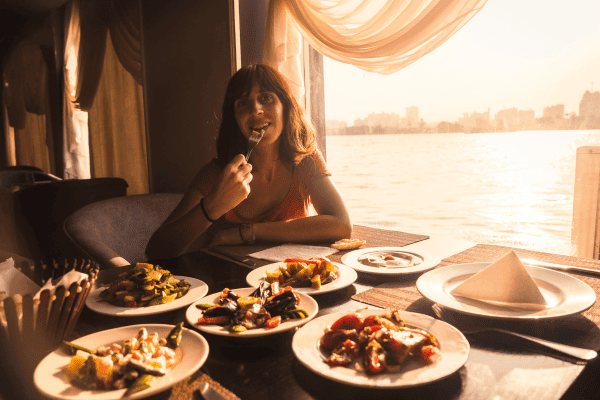 Enjoying dinner on a Nile Cairo showboat with a view of the city skyline.