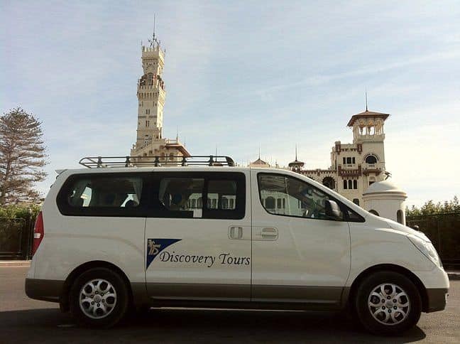 Discovery Tours minibus parked outside El Montazah Palace in Alexandria, Egypt.
