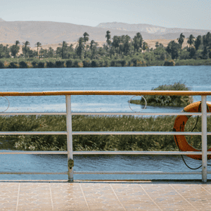 View from a Nile cruise boat overlooking the river and lush greenery in Egypt.