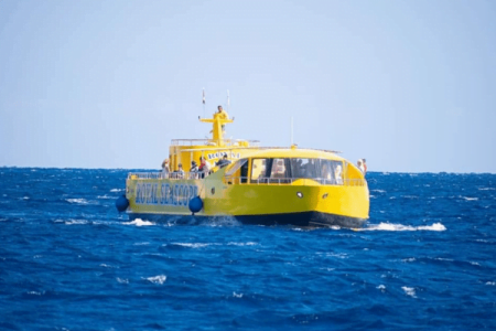 Yellow tourist submarine boat on blue ocean