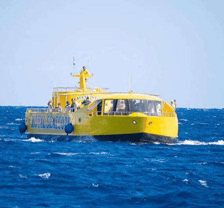 Yellow tourist submarine boat on blue ocean