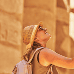 Visitor admiring ancient Egyptian columns.