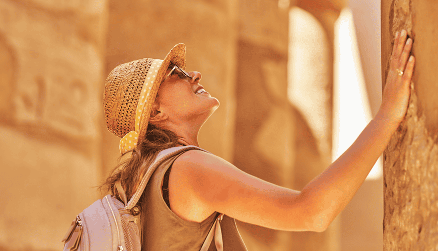 Visitor admiring ancient Egyptian columns.