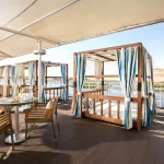 River view outdoor dining area on cruise deck.