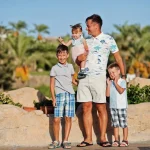 Family enjoying a sunny holiday outdoors in Egypt, experiencing the beauty and culture with Discovery Tours Egypt.