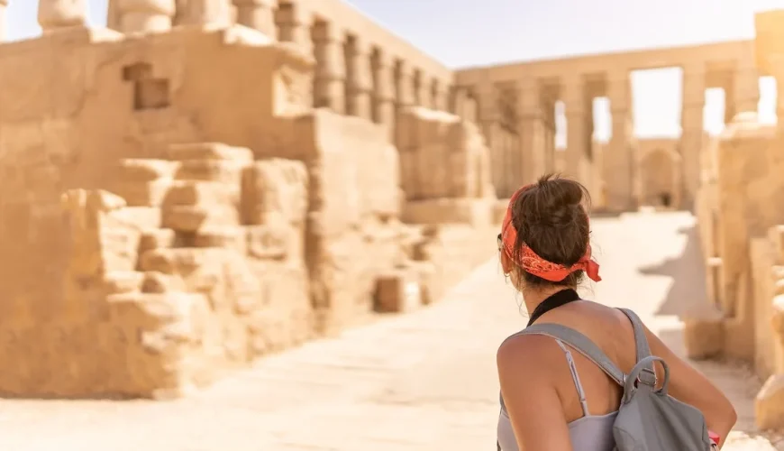 Traveler exploring the ancient ruins at Karnak Temple in Luxor, Egypt.