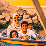 Family enjoying a theme park water ride.