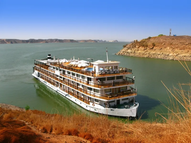 Luxury river cruise ship on tranquil waters.