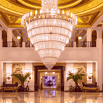 Opulent hotel lobby with grand chandelier.