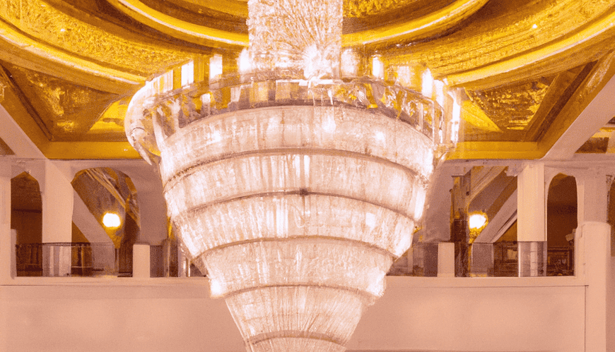 Opulent hotel lobby with grand chandelier.
