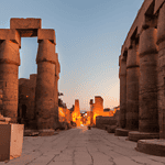 Ancient Egyptian temple ruins at sunset.