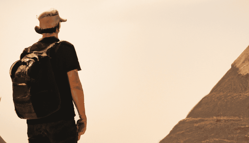 Man observing pyramids, travel adventure concept.