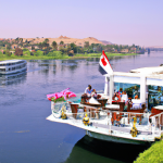 River cruise boats on Nile, Egypt with tourists.