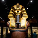 Golden Egyptian pharaoh mask on display in museum.