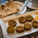 Full English breakfast with sausages, eggs, and flatbread.