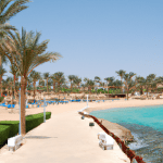 Tropical beach resort with palm trees and clear blue water
