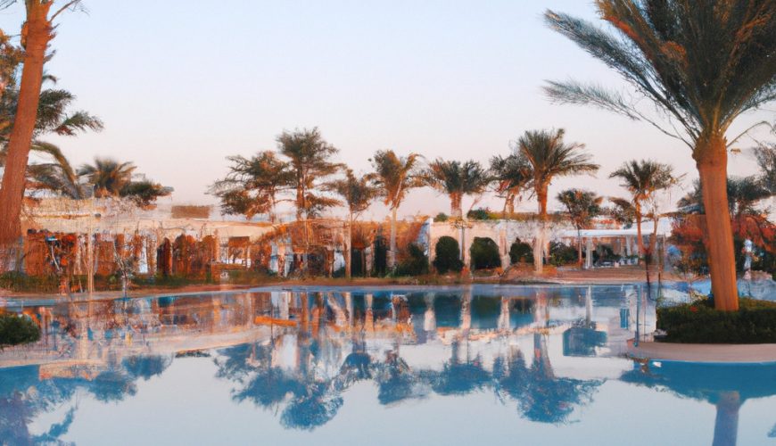 Tropical resort pool with palm tree reflections at sunset.