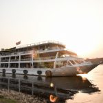 Sunset view of an anchored riverboat.