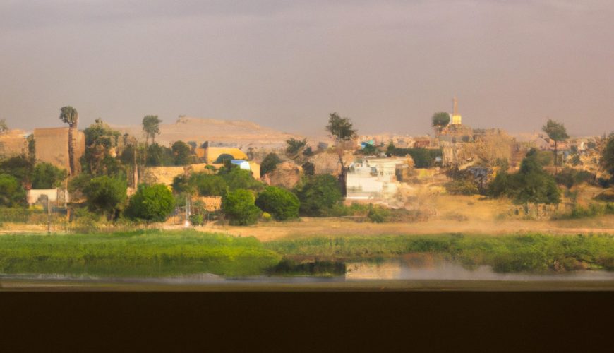 Rural landscape with river and buildings through window.