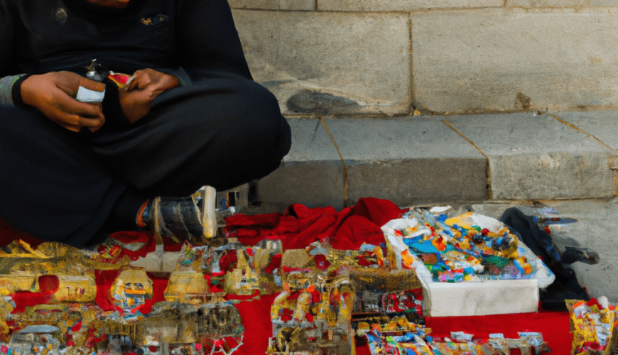 Street vendor selling colorful crafts on a red cloth.