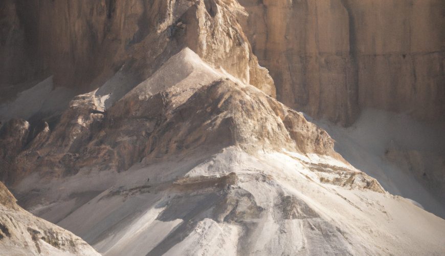 Visitors walking towards a mountainous desert landscape